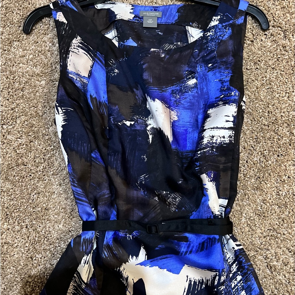Blue, black and white patterned blouse.